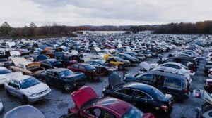 Wide view of a large car junkyard in Chattanooga with numerous vehicles showing signs of wear.
